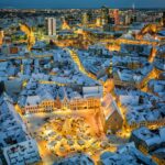 an aerial view of a snowy city at night