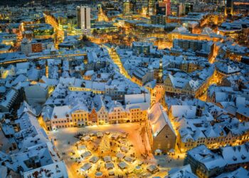 an aerial view of a snowy city at night