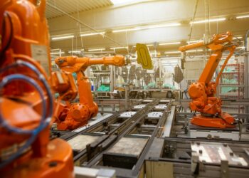 a factory filled with lots of orange machines