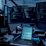 a desk with several monitors