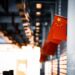 a chinese flag hanging from the side of a building