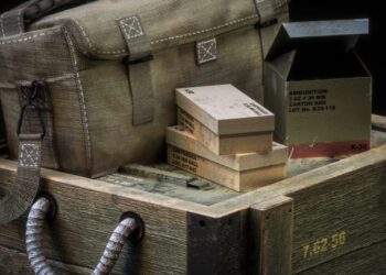 Military canvas bag and boxes on wooden crates