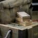 Military canvas bag and boxes on wooden crates