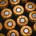 A close-up view of brass 45 auto cartridge casings arranged in a grid