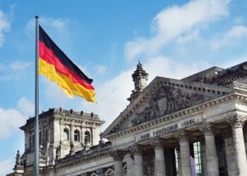 The German flag flying above the Reichstag building in Berlin, Germany