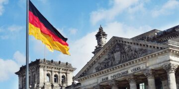 The German flag flying above the Reichstag building in Berlin, Germany