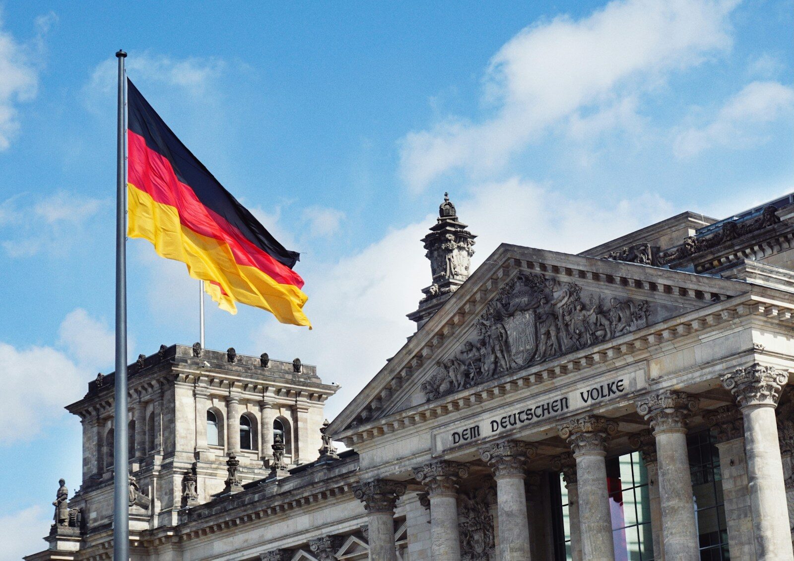 The German flag flying above the Reichstag building in Berlin, Germany