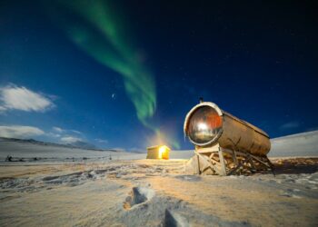 a telescope sitting on top of a snow covered field