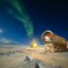 a telescope sitting on top of a snow covered field