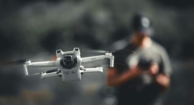 A person controlling a drone.